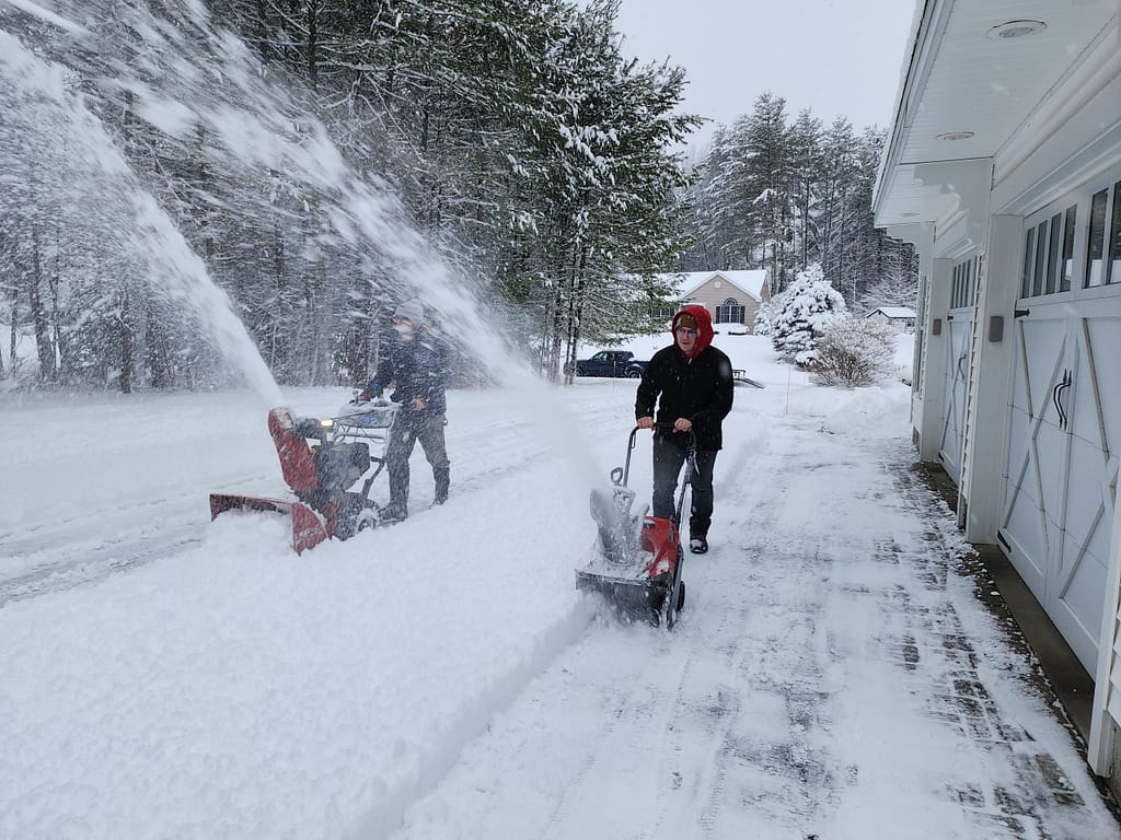 men snow blowing in Queensbury